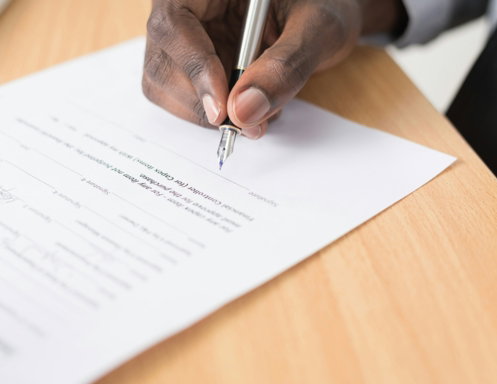 person writing on white paper